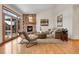 Cozy living room featuring stone fireplace, wood floors, and large windows at 1294 Red Lodge Dr, Evergreen, CO 80439