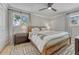 Cozy bedroom with a ceiling fan, two windows, neutral decor, and a comfortable bed at 5080 S Boston St, Greenwood Village, CO 80111