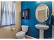 Stylish powder room with pedestal sink and blue walls at 1303 Yellow Granite Way, Monument, CO 80132