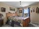 Cozy bedroom with wooden bed frame and rustic decor at 1303 Yellow Granite Way, Monument, CO 80132