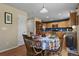 Dining area with pumpkin tablecloth, open to the kitchen and living room at 1303 Yellow Granite Way, Monument, CO 80132