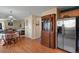 Kitchen and dining area with hardwood floors and a view into the living room at 1303 Yellow Granite Way, Monument, CO 80132