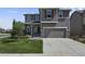 Two-story house with gray siding, a two-car garage, and a well-maintained lawn at 1303 Yellow Granite Way, Monument, CO 80132