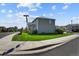 Gray two-story house with green lawn, located on a corner lot at 1303 Yellow Granite Way, Monument, CO 80132