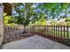 Backyard space with rock and mulch landscaping, a small tree, and a wood fence at 10480 Truckee St # B, Commerce City, CO 80022
