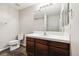 Clean bathroom featuring a tile floor, toilet, sink with vanity and large mirror at 10480 Truckee St # B, Commerce City, CO 80022