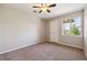 Cozy bedroom features neutral walls, plush carpet, and a bright window letting in natural light at 10480 Truckee St # B, Commerce City, CO 80022