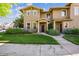 Charming tan two-story home with well-manicured lawn and stone accents at 10480 Truckee St # B, Commerce City, CO 80022