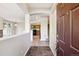 Open concept foyer with tile floors, leading to kitchen and staircase at 10480 Truckee St # B, Commerce City, CO 80022