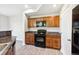 Kitchen features granite countertops, cabinets, and modern black appliances at 10480 Truckee St # B, Commerce City, CO 80022