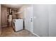 A modern laundry room features a new washer and dryer, tiled floor and plenty of storage space at 10480 Truckee St # B, Commerce City, CO 80022