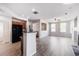 Open-concept living room with hardwood floors and archway leading to kitchen, great for entertaining at 10480 Truckee St # B, Commerce City, CO 80022
