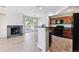Bright, open-concept living space flows from the kitchen with a cozy fireplace at 10480 Truckee St # B, Commerce City, CO 80022