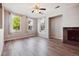 Bright and airy living room featuring hardwood floors and multiple large windows at 10480 Truckee St # B, Commerce City, CO 80022