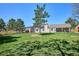 Spacious, grassy backyard with covered patio offering serene outdoor living and entertaining at 5172 S Cody Ct, Littleton, CO 80123