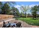 A cozy backyard with a fire pit and trampoline provides space for both relaxation and recreation at 5172 S Cody Ct, Littleton, CO 80123