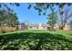 A sprawling green backyard features a covered patio, offering an ideal outdoor living space at 5172 S Cody Ct, Littleton, CO 80123