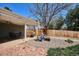 Backyard space with covered patio, outdoor seating, and a fire pit area for entertaining at 5172 S Cody Ct, Littleton, CO 80123