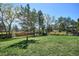 Well-maintained backyard with lush green lawn and mature trees, ideal for recreation and privacy at 5172 S Cody Ct, Littleton, CO 80123
