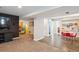 Finished basement featuring playroom with hardwood floors, carpet, and a flat screen tv at 5172 S Cody Ct, Littleton, CO 80123