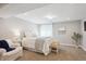 Calm, carpeted bedroom with natural light, a queen-size bed, and a white chair at 5172 S Cody Ct, Littleton, CO 80123