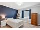 Comfortable bedroom with cozy decor, featuring a window seat and ample natural light at 5172 S Cody Ct, Littleton, CO 80123