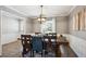 Bright dining room with a wooden table and chairs under a modern chandelier, great for gatherings at 5172 S Cody Ct, Littleton, CO 80123