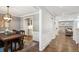 Spacious dining room adjacent to kitchen featuring hardwood floors and access to other living areas at 5172 S Cody Ct, Littleton, CO 80123