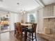 Dining room features a wooden table, blue upholstered chairs, and sliding door to the outdoor patio at 5172 S Cody Ct, Littleton, CO 80123