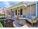 Inviting front porch with comfortable seating around a stylish fire pit in front of the charming home at 5172 S Cody Ct, Littleton, CO 80123