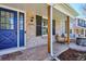 Cozy front porch featuring exposed wood posts, comfortable seating around a fire pit, and shade at 5172 S Cody Ct, Littleton, CO 80123