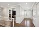 Elegant hallway with hardwood floors, white trim, and French doors leading to the office at 5172 S Cody Ct, Littleton, CO 80123