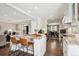 Open concept kitchen with a granite island, breakfast bar, and modern white cabinetry at 5172 S Cody Ct, Littleton, CO 80123