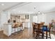 Bright and spacious kitchen features an island with bar seating, white cabinets, and an adjacent dining area at 5172 S Cody Ct, Littleton, CO 80123