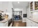 Bright kitchen featuring white cabinets, granite countertops, stainless appliances, and wood flooring at 5172 S Cody Ct, Littleton, CO 80123