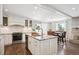 Open kitchen boasts a center island, white cabinetry, stainless steel appliances, and a breakfast nook at 5172 S Cody Ct, Littleton, CO 80123