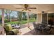 Covered patio area with ceiling fans, outdoor furniture, and views of the landscaped backyard at 5172 S Cody Ct, Littleton, CO 80123