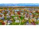 Beautiful aerial view of neighborhood near lake featuring playground, basketball court, and mature trees at 1647 Harris Ct, Erie, CO 80516