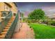 Landscaped backyard featuring stairs leading to a patio and grassy area at 1647 Harris Ct, Erie, CO 80516
