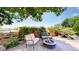 Inviting backyard patio features a cozy fire pit and comfortable seating amid lush greenery at 1647 Harris Ct, Erie, CO 80516
