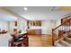 Finished basement with wood floors, bar area, and stairwell at 1647 Harris Ct, Erie, CO 80516