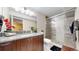 Modern bathroom with granite countertop, glass shower, and pebble floor at 1647 Harris Ct, Erie, CO 80516