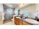 Beautiful bathroom with dual sinks, walk-in shower, and decorative tile accents at 1647 Harris Ct, Erie, CO 80516