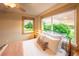 Bright bedroom featuring large windows with picturesque lake and greenery views at 1647 Harris Ct, Erie, CO 80516