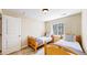 Cozy bedroom with two twin beds, a window, and a closet at 1647 Harris Ct, Erie, CO 80516