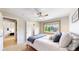 Comfortable bedroom with a ceiling fan, large window, and access to an ensuite bathroom at 1647 Harris Ct, Erie, CO 80516