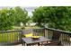 View from a deck with a table, chairs, and lake views in the distance at 1647 Harris Ct, Erie, CO 80516