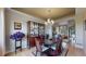 Formal dining room featuring a chandelier, hardwood floors, and a built-in china cabinet at 1647 Harris Ct, Erie, CO 80516