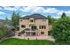 Exterior of a home with a deck, patio, and spacious backyard at 1647 Harris Ct, Erie, CO 80516
