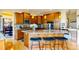 Spacious kitchen boasts custom cabinets, granite countertops, island with seating and stainless steel appliances at 1647 Harris Ct, Erie, CO 80516